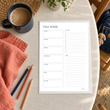Actual This Week page with seven day spaces, a to-do list and notes, printed on a warm home table.