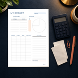 Actual January budget worksheet on a navy desk with a calculator and blank receipts.