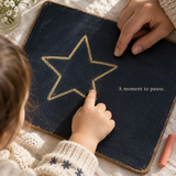 Child tracing a simple star-shaped line with a supportive adult nearby, representing a pause activity; illustrative, not an exact PDF page