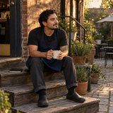 Illustrative cafe worker taking a reflective pause outdoors