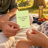 Actual perfect-date question card being shared on an outdoor picnic